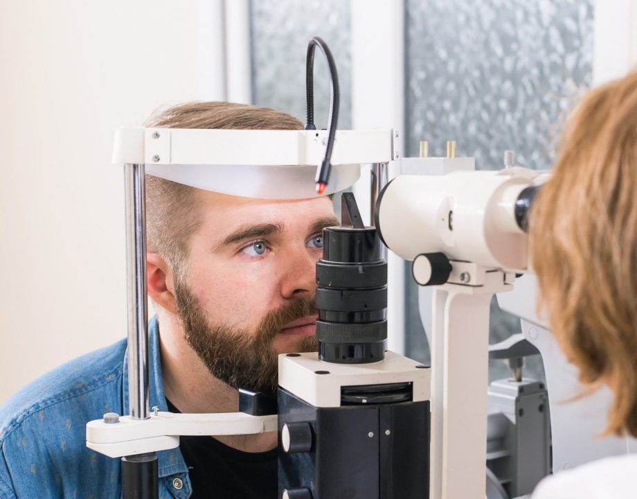 Medicine, ophthalmology concept - patient checks her vision by an ophthalmologist.